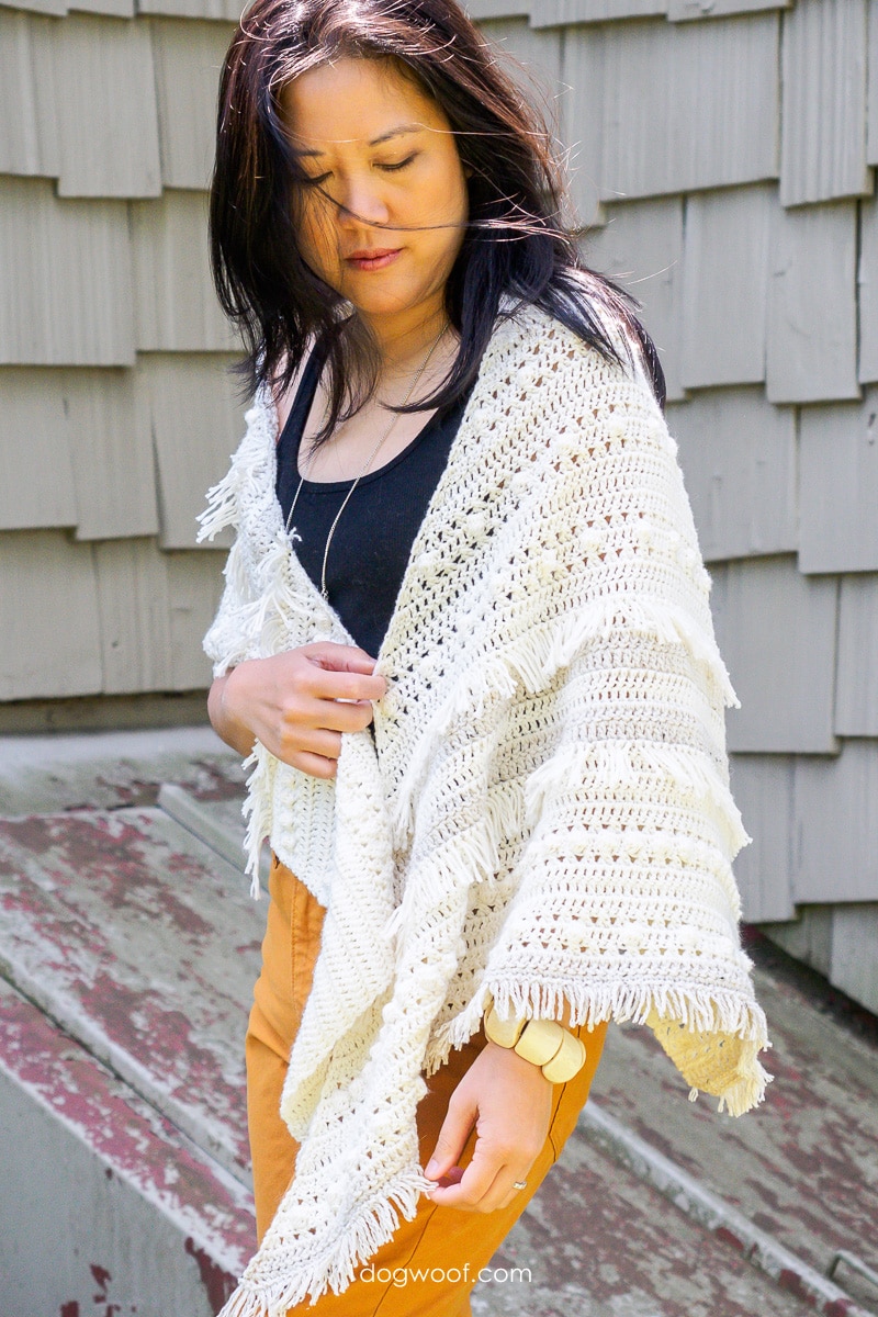 model wearing crochet fringe shawl